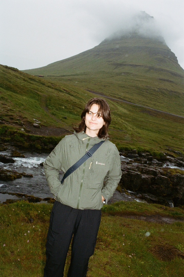 Sage Taber beside a mountain river